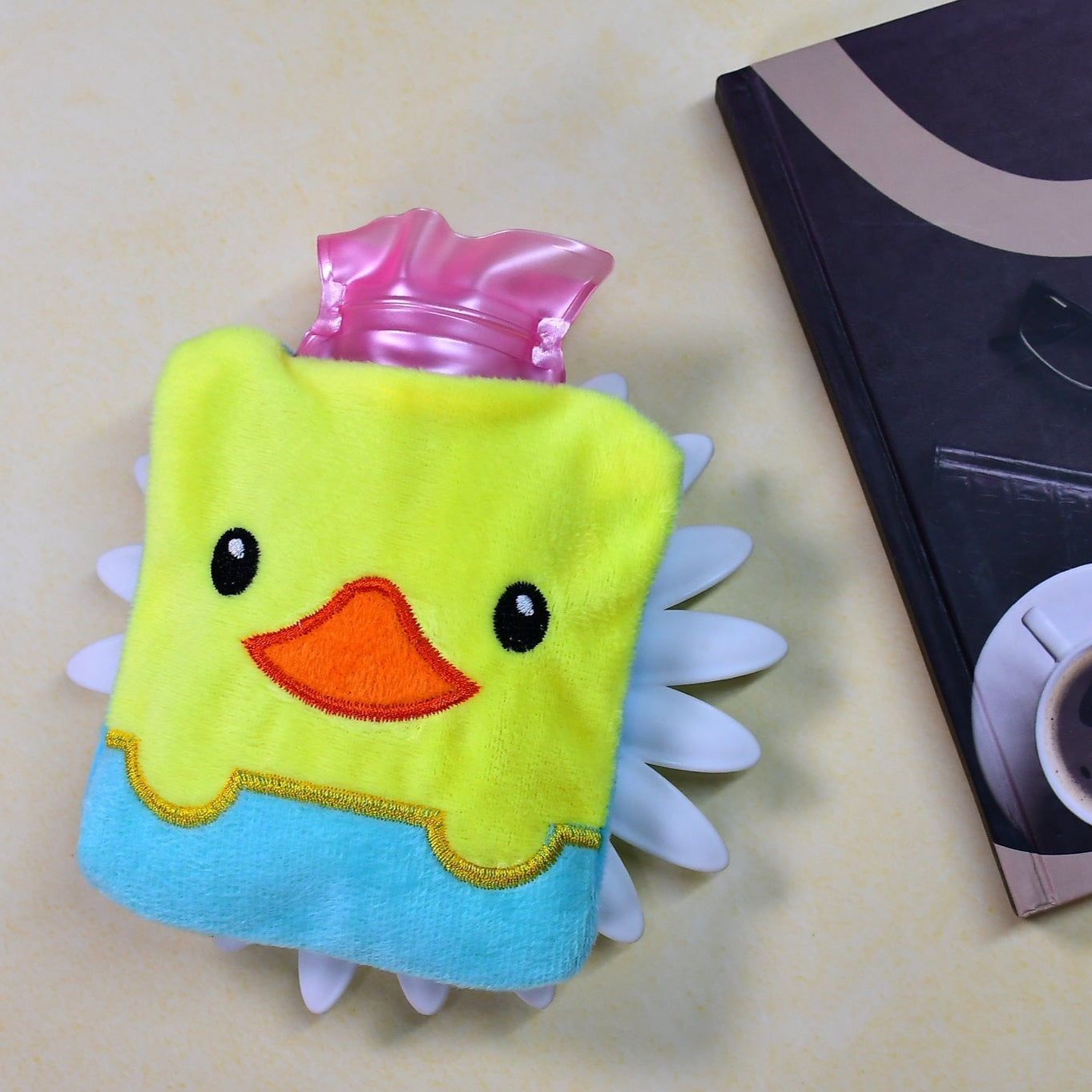 Cute yellow duck hot water bag with cover for neck pain relief.