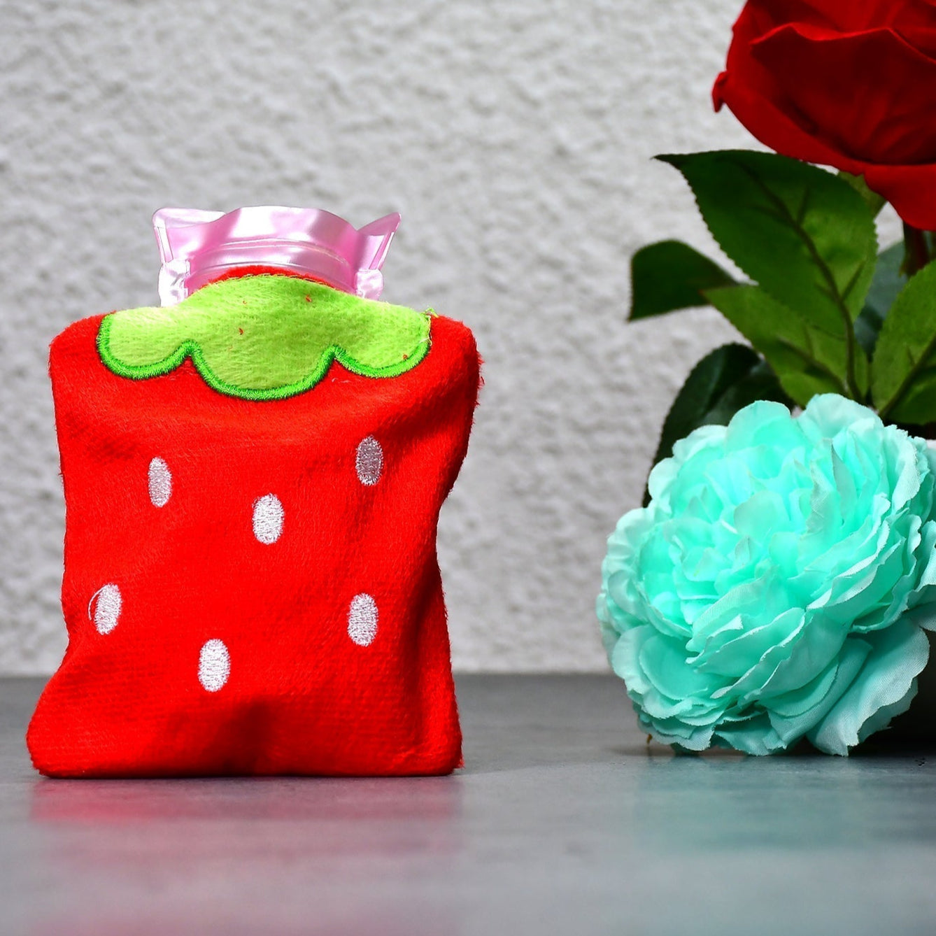 Strawberry design hot water bag, ideal for neck pain relief.